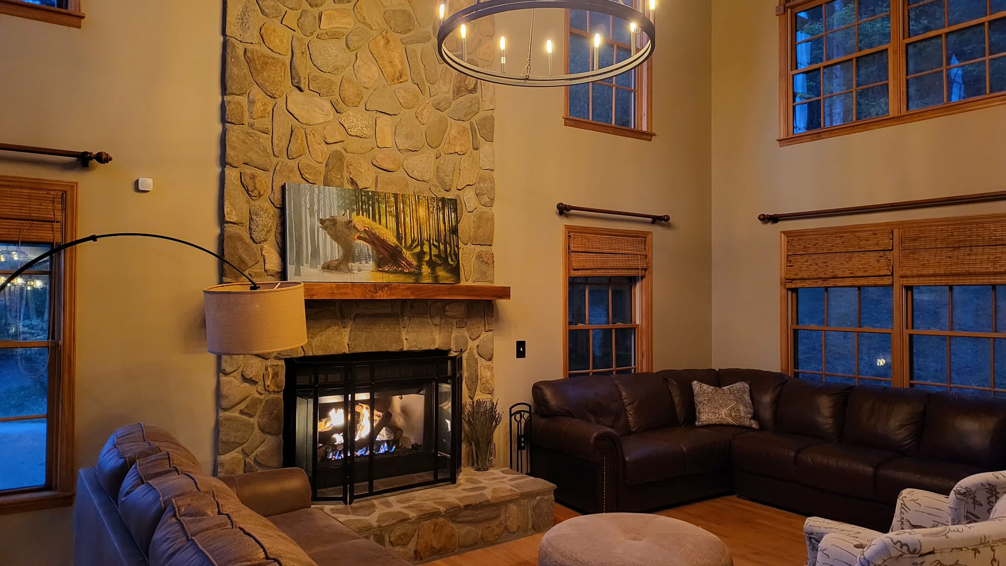 Living room at sundown with fireplace glowing and warm evening light